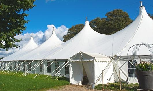 a row of portable restrooms placed outdoors for attendees of a special event in Waterford